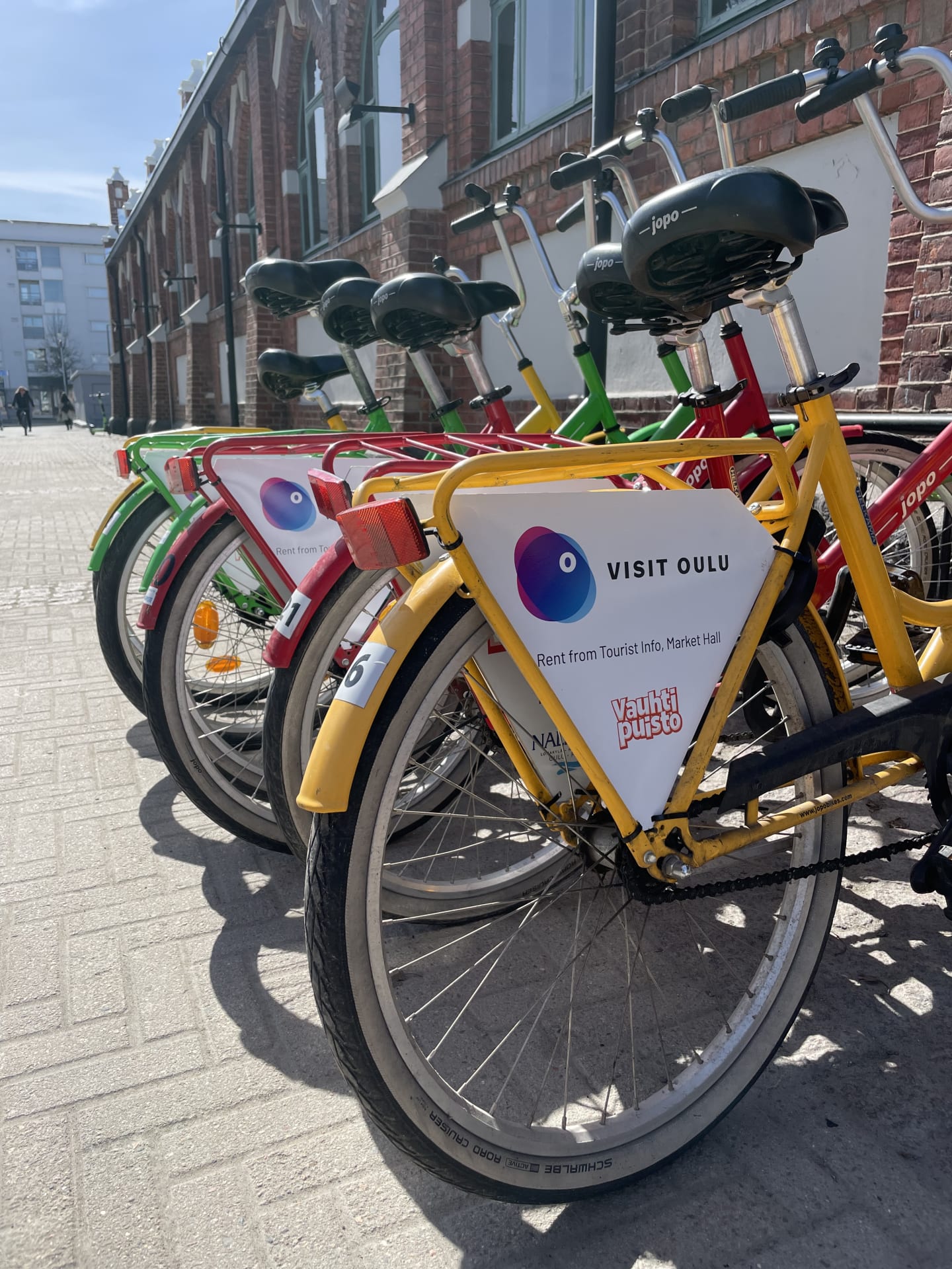 6 colorful bikes next to the Market Hall.