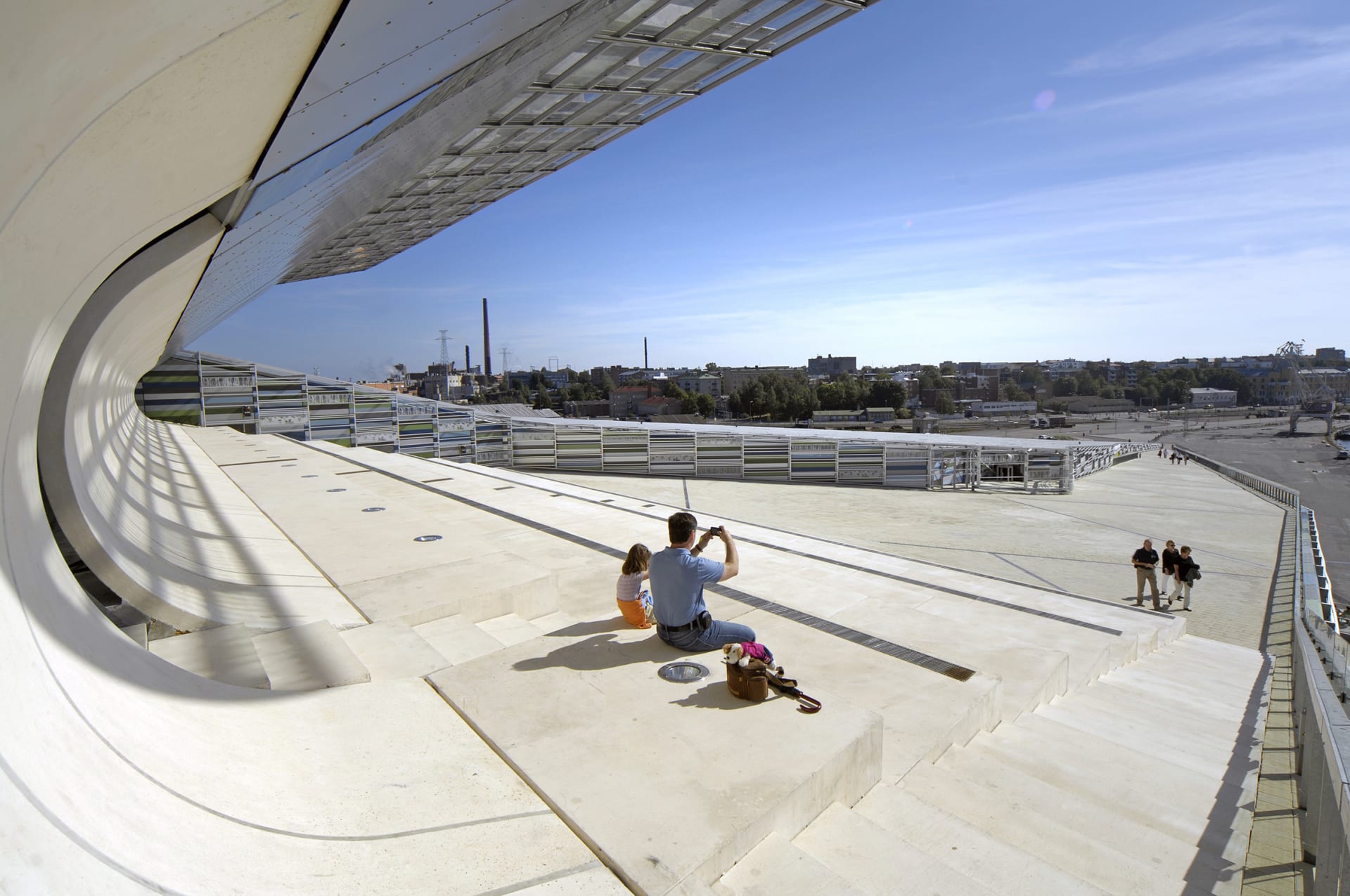 Man and child taking a photo on the roof top of Vellamo.