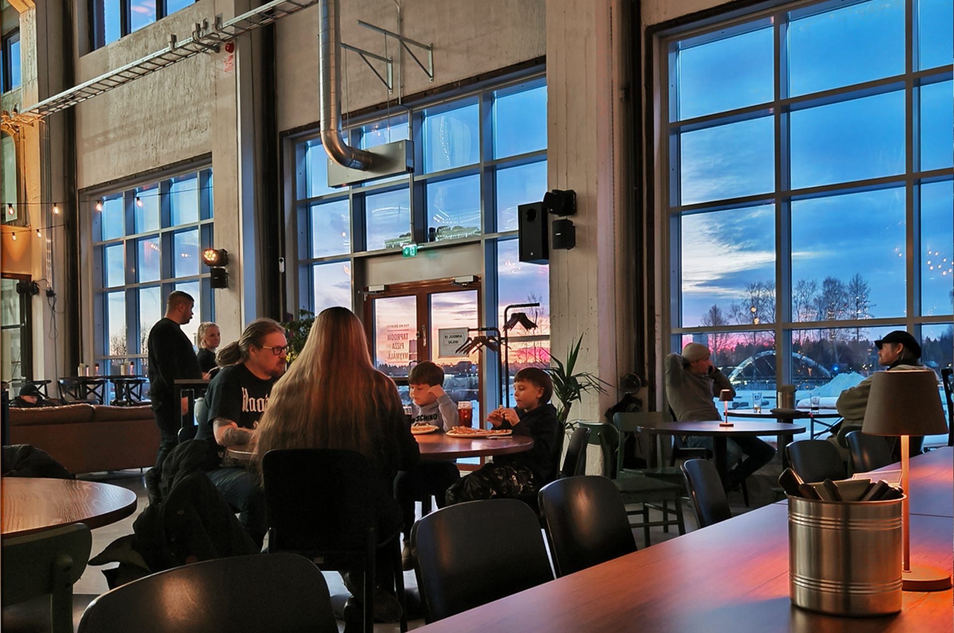 Family dinner at the brewery restaurant with large windows overlooking the Oulu river delta