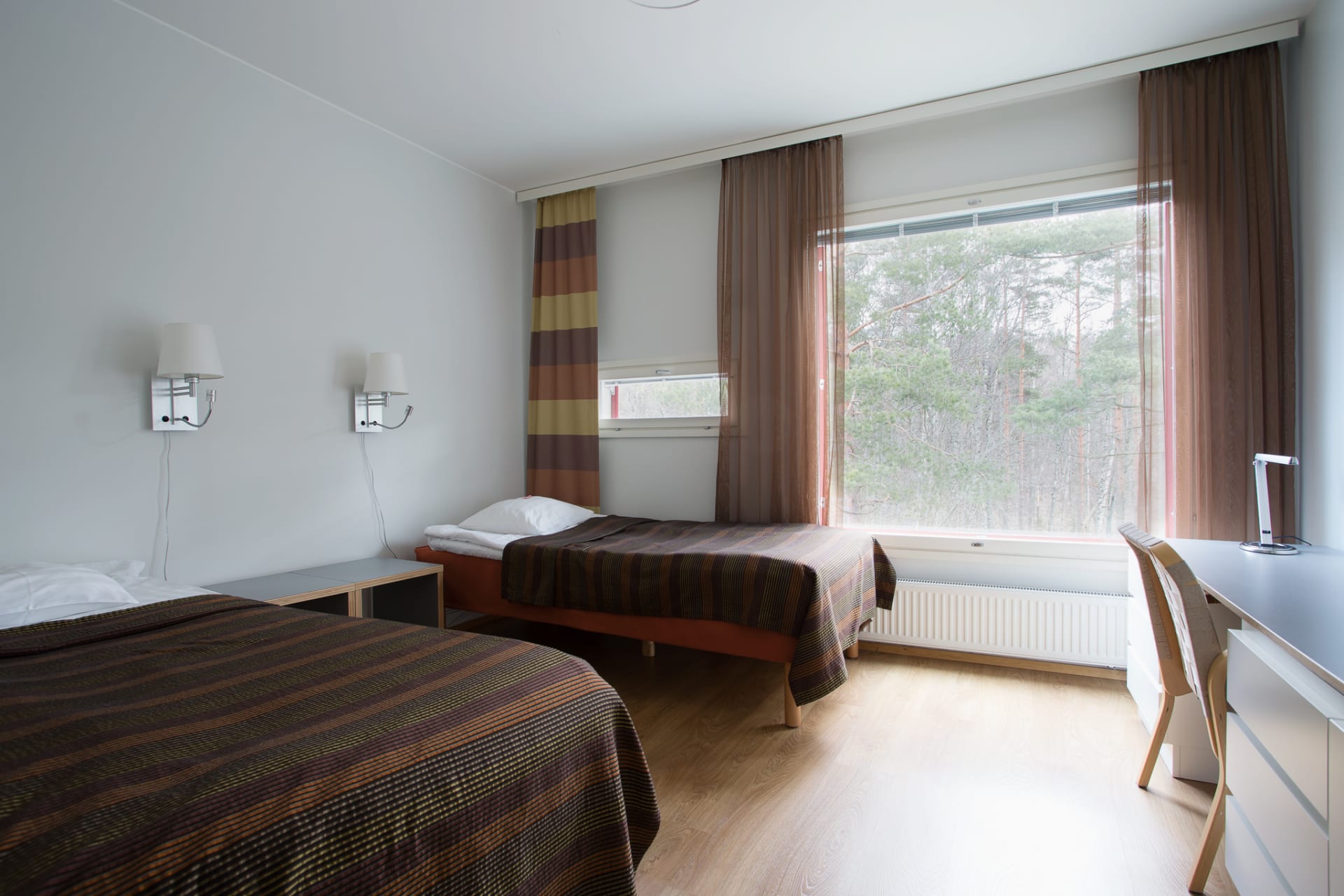 Bedroom in apartment surrounded bu nature.