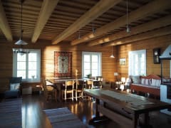 The axe-carved greatroom with a large dining table.