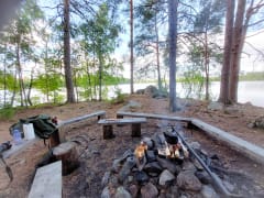 Nuotiopaikka Vähäniemessä taustalla järvimaisema / Campfire site at Vähäniemi lake view in the backround