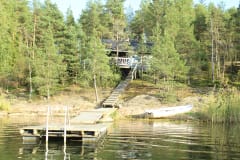 Pieni hirsimökki Pikku-Keisari sijaitsee rantakallioilla ilta-auringon suuntaan.