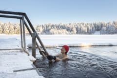 Woman swimming in icewater swimming place.