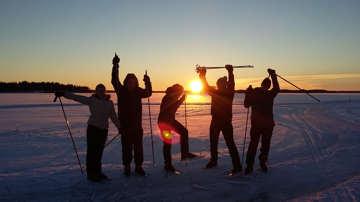 Skaters on the ice route in sunset