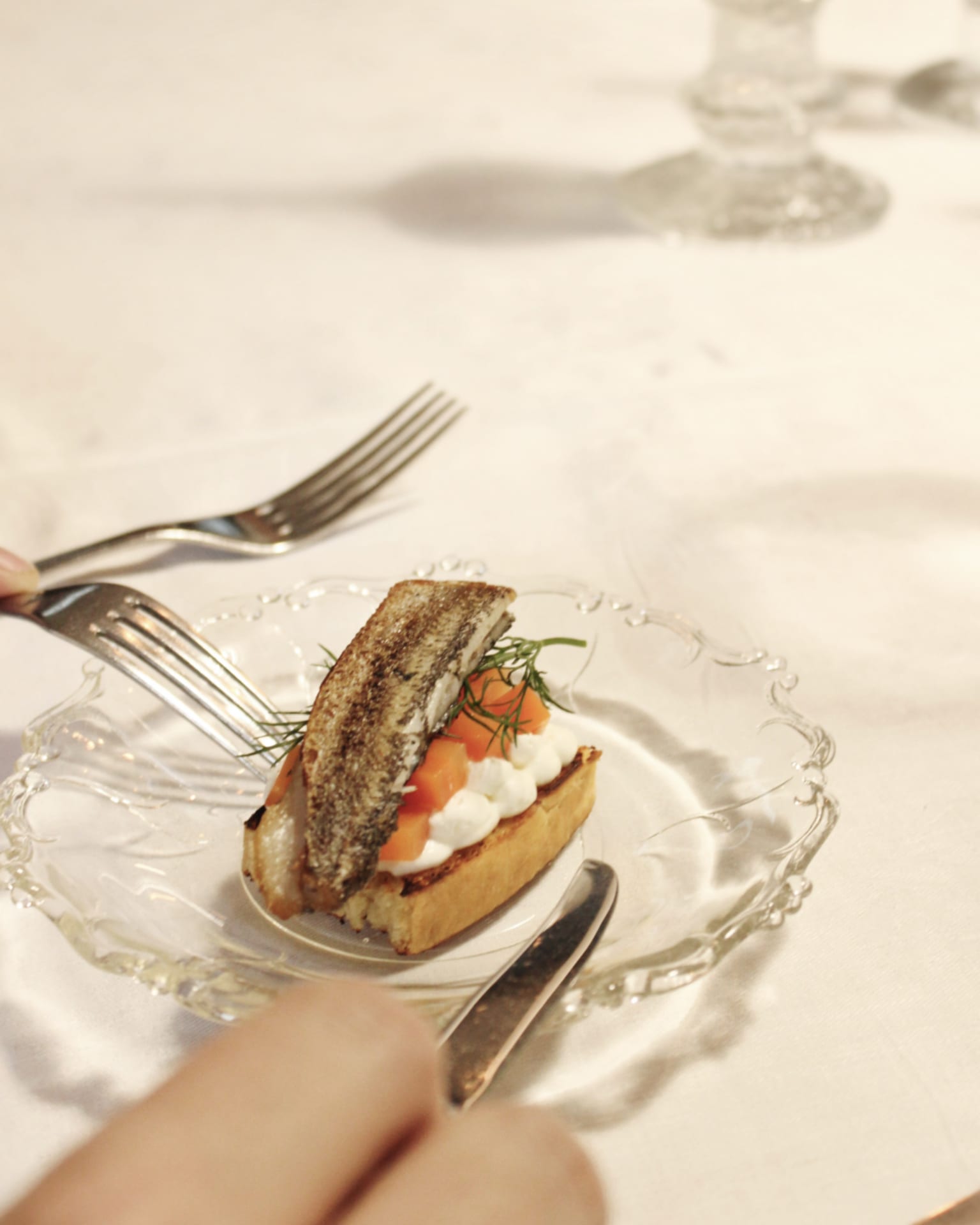 Dish with Baltic herring and potato. The dish is assembled on an old glass plate.