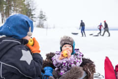 Families with kids on the frozen lake