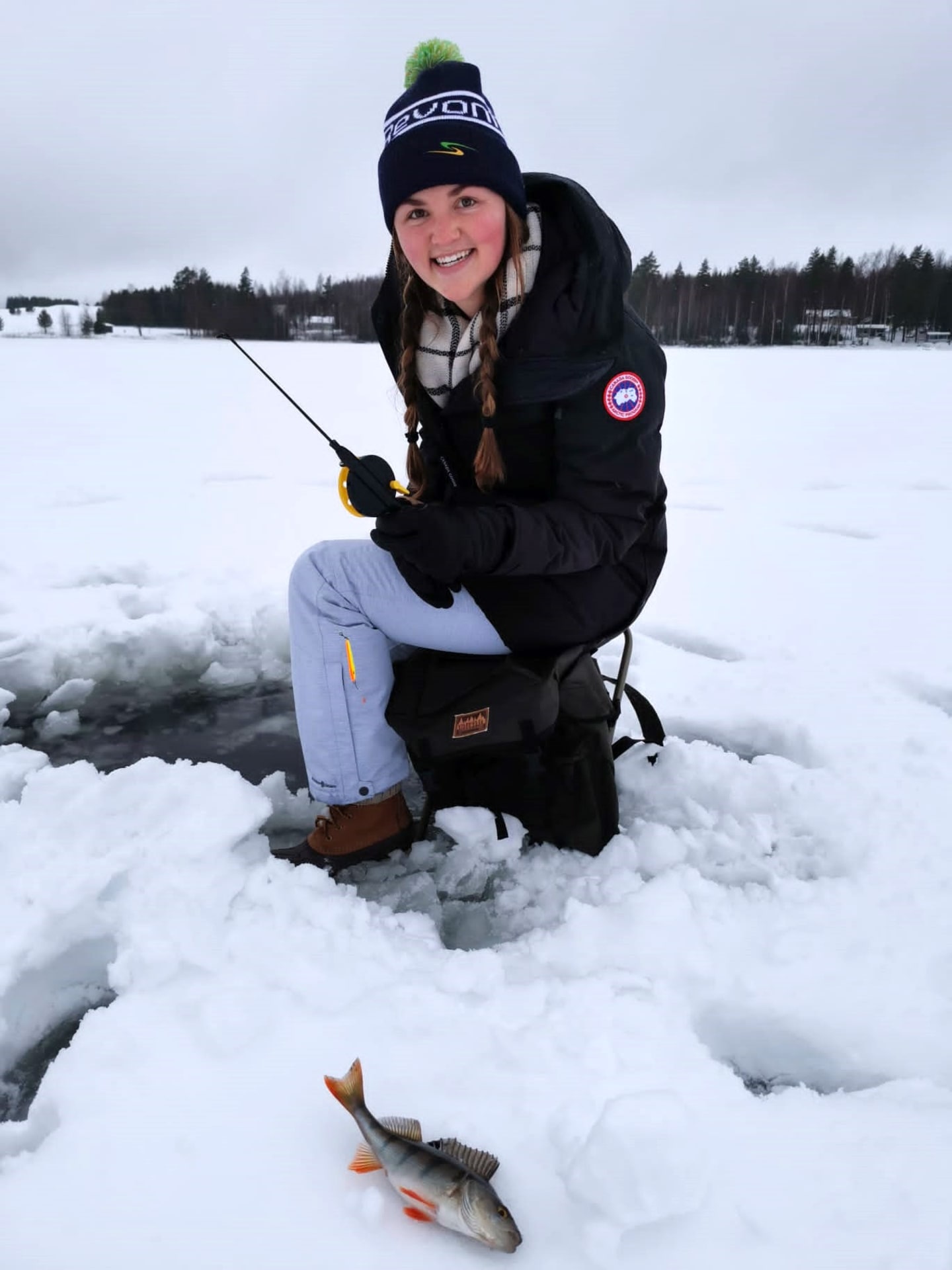Woman ice fishing winter