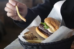 Hamburger and french fries in a basket.