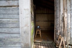 Indoor washing facility has wood burning boiler, cold water pump and some dishes for washing.