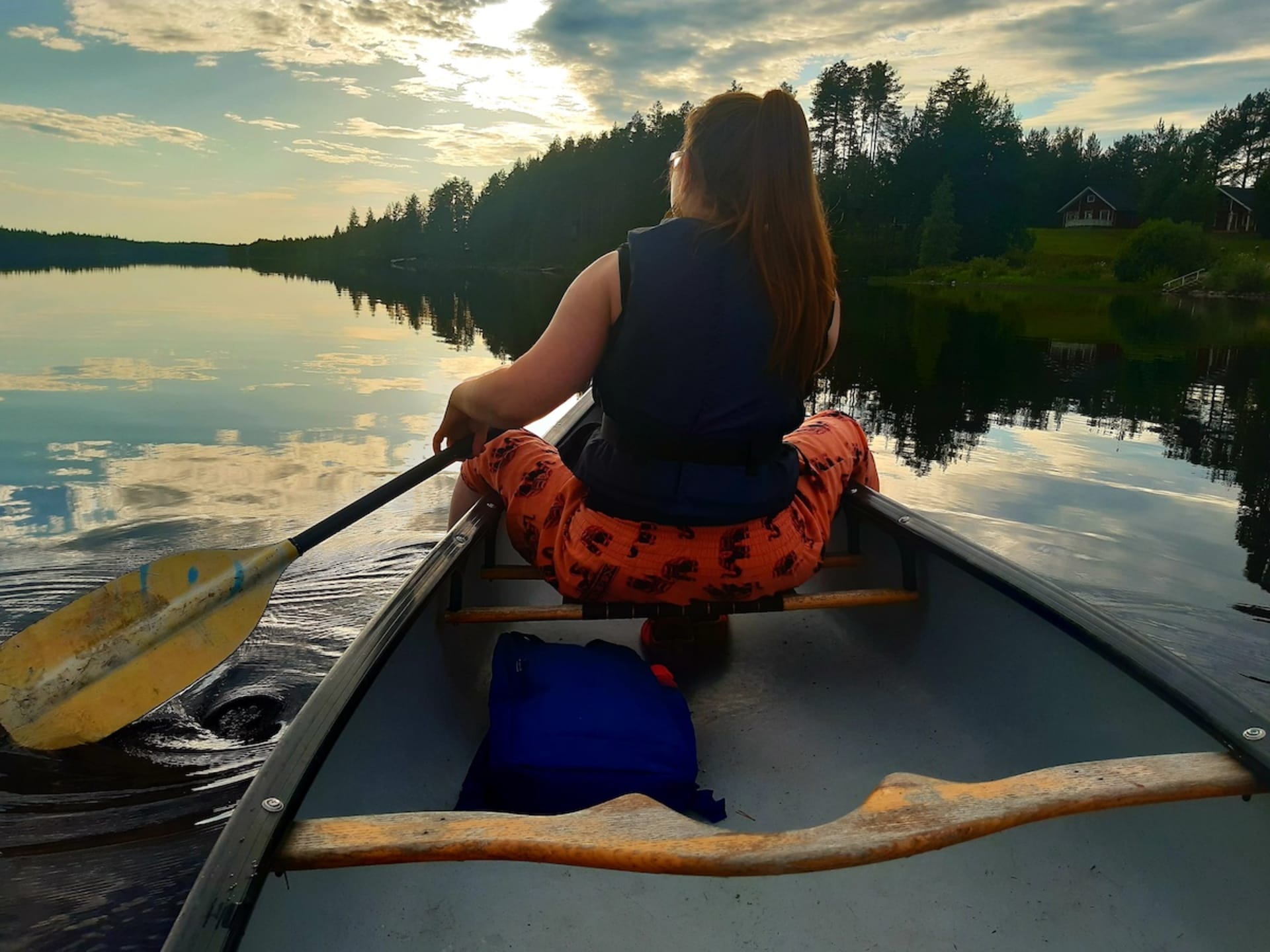 Woman paddling on a lake.