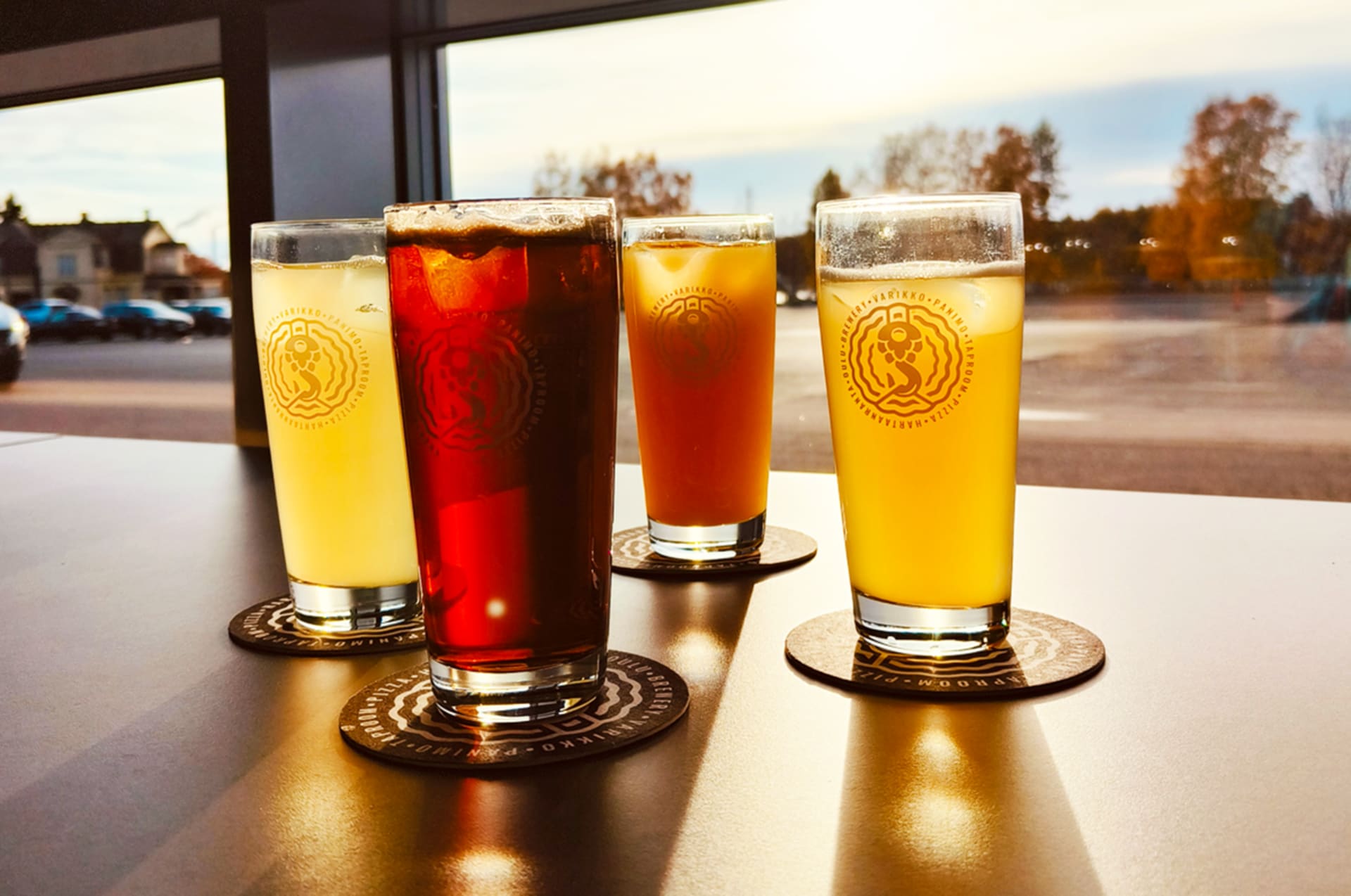 Selection of four varied and colorful local beers on tap at Varikko, catching the sun