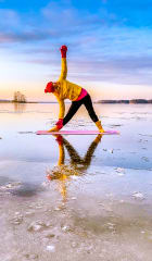 Snow Yoga on ice, triangle pose.