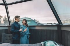 Couple inside of a Glass Igloo.