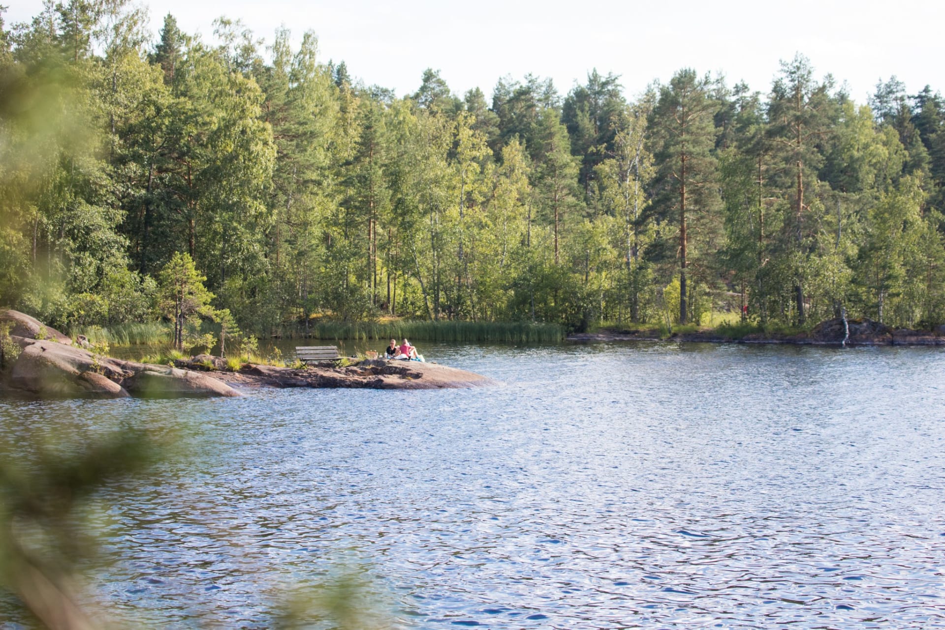 people enjoy a summer day on the cliff of Sulosaari
