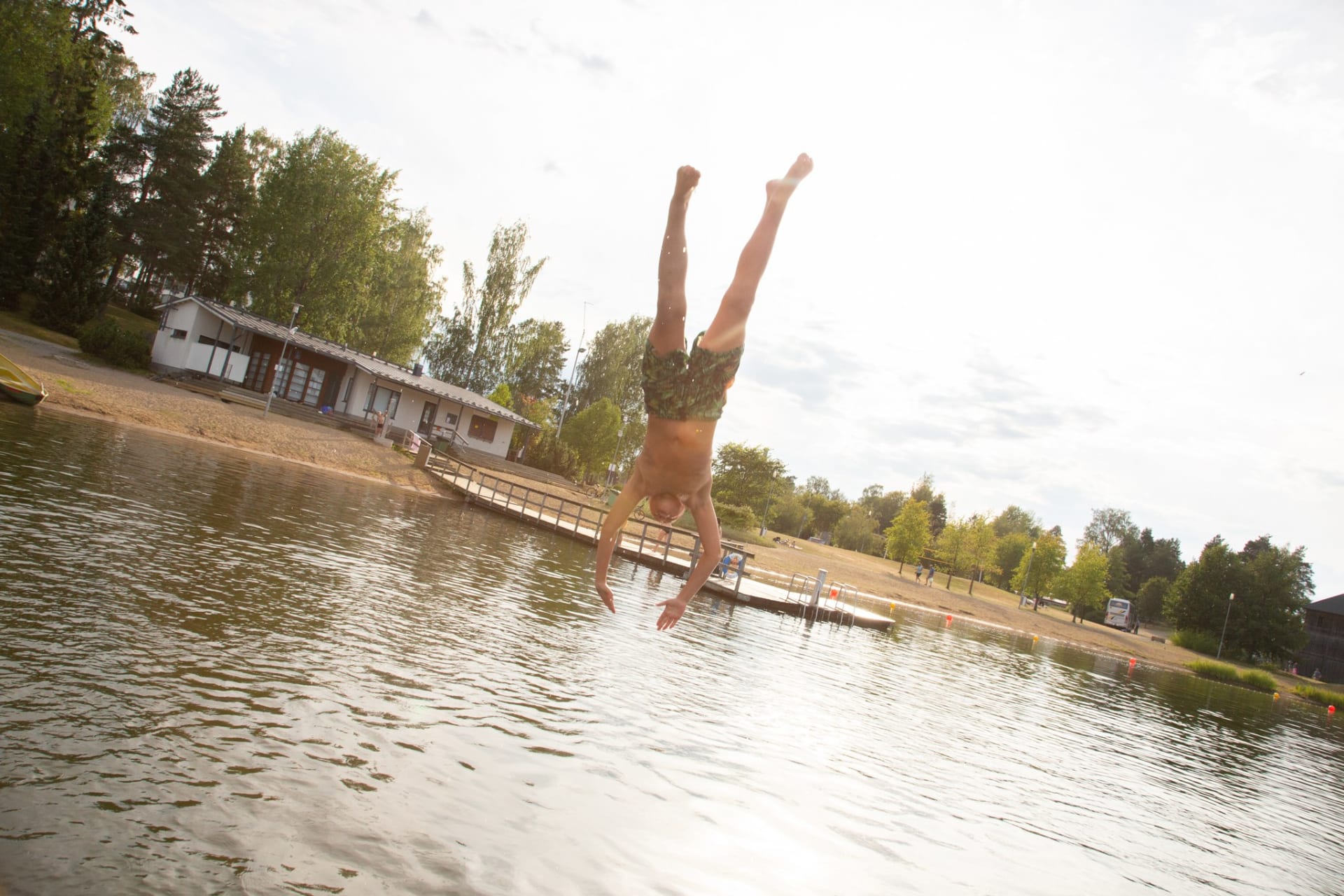 A boy jumps from the pier to the water at Apianlahti beach in Valkeakoski.