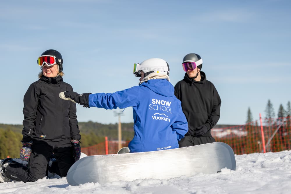 Ski instructor teaches snowboarding