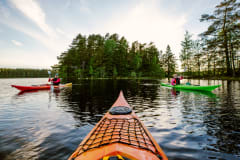 Three persons kayaking in lake Matildanjärvi
