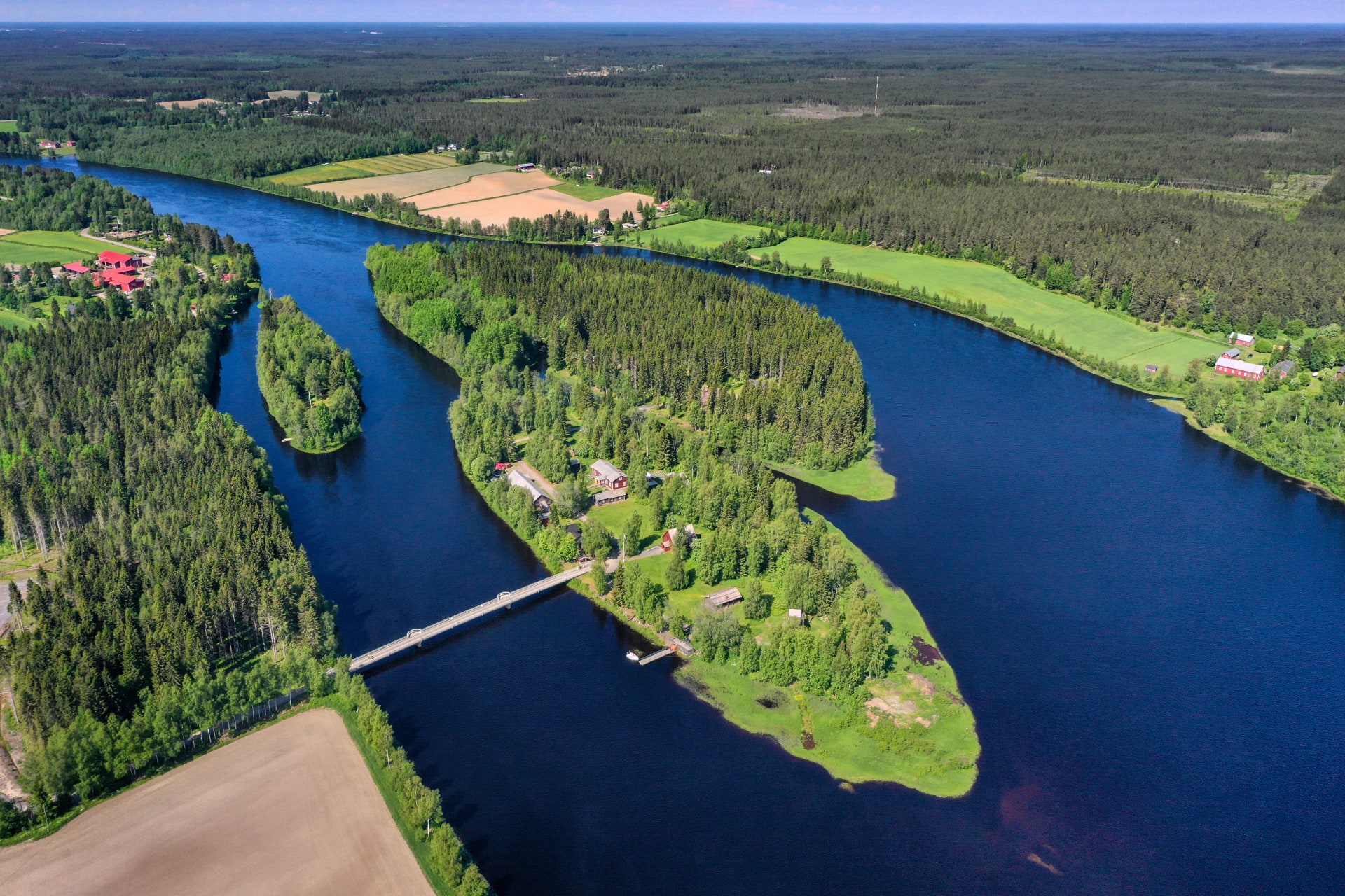 Archipelago in the middle of the river. A bridge leading to the island from the mainland.