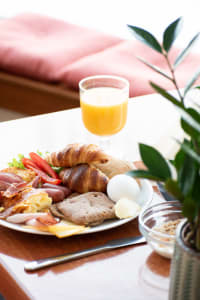 A breakfast plate with a glass of juice.
