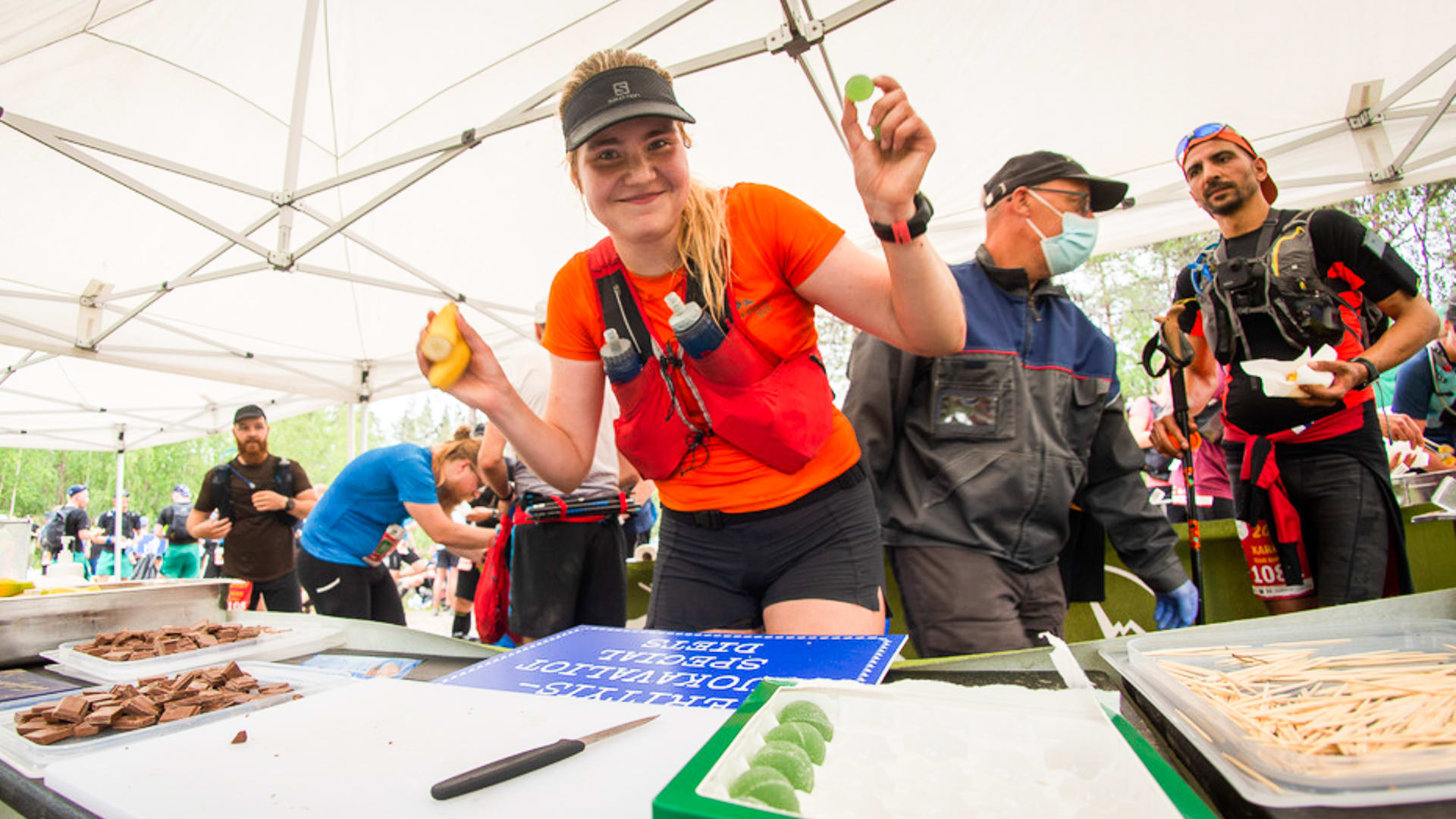 Trail runner holds food in hands