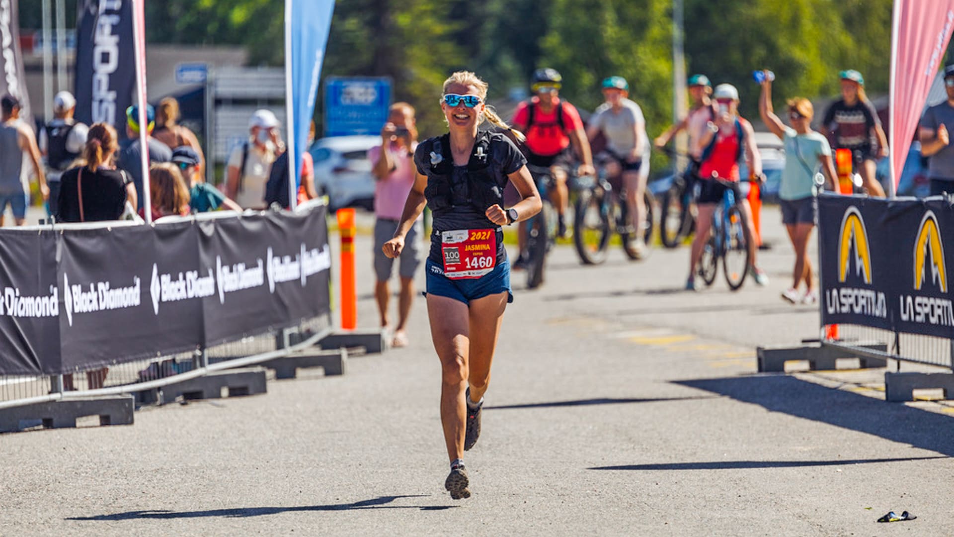 Trail runner coming to finish line on a sunny day