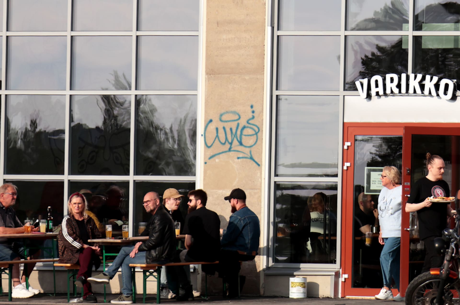 House-made long drink and fresh salads on a rustic table at Varikko brewery restaurant
