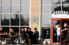 House-made long drink and fresh salads on a rustic table at Varikko brewery restaurant
