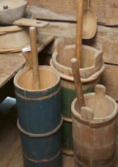 In the picture, there are old butter churns.