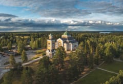 aerial image of yellow wooden church in summer