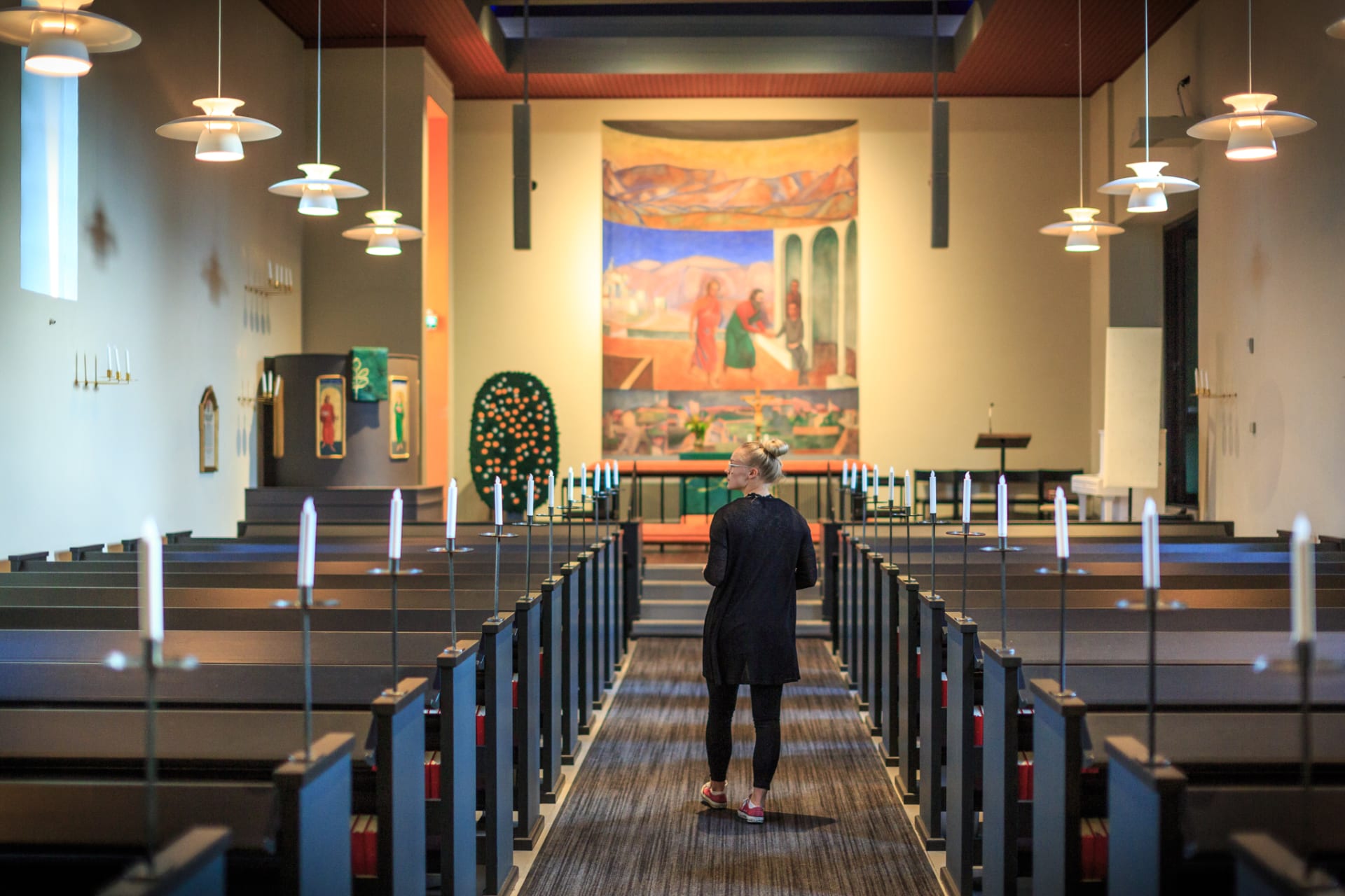 Muurame Church, inside, person standing on aisle. 