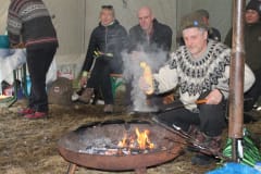Making pancakes beside open fire