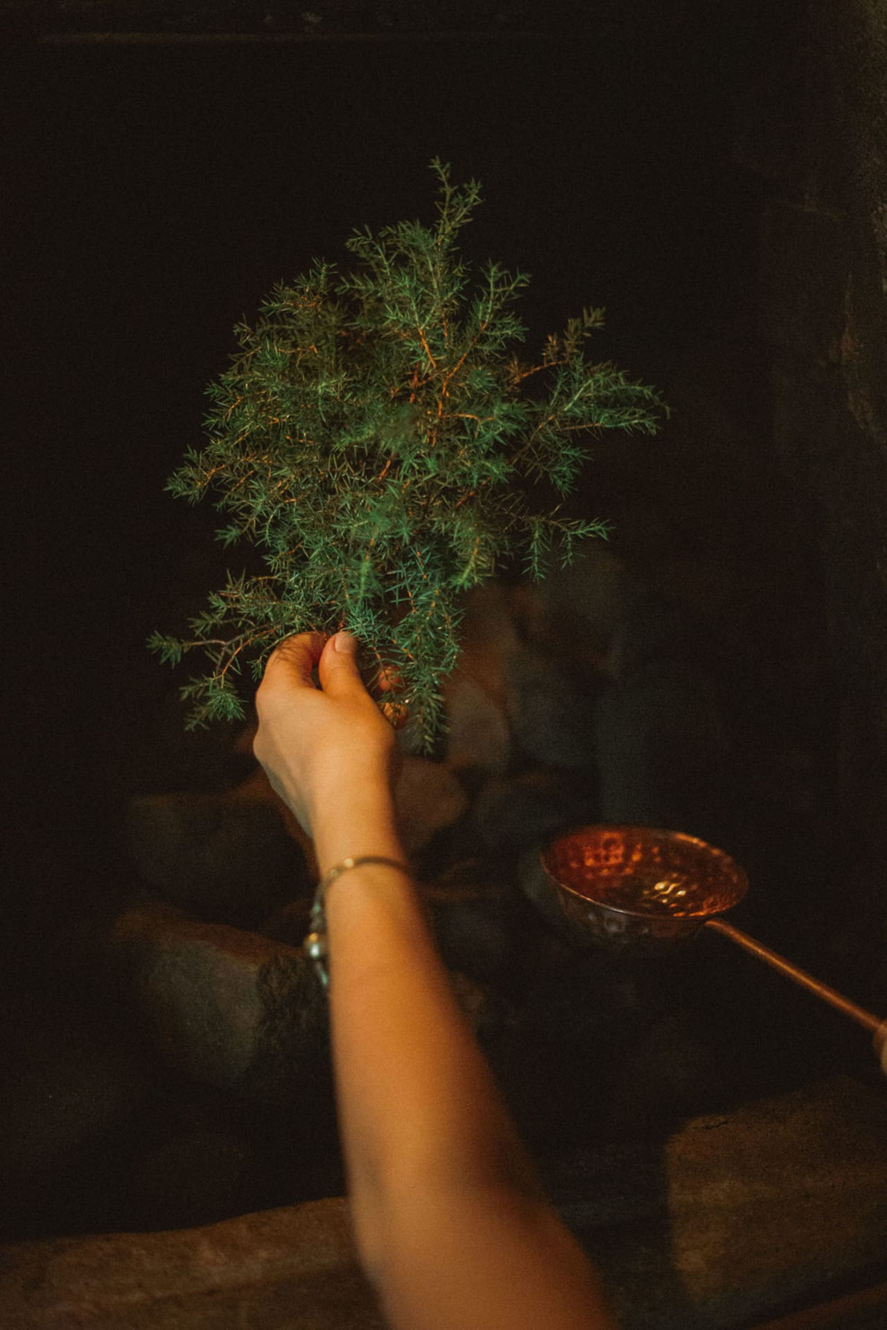 Pouring löyly with juniper Pouring löyly with juniper