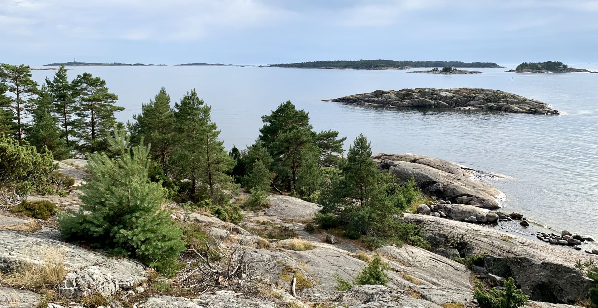 The scene from the Cape of Porkkala peninsula showcases small islands and a lighthouse. 