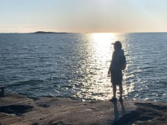 Man gazing into the horizon by the sea