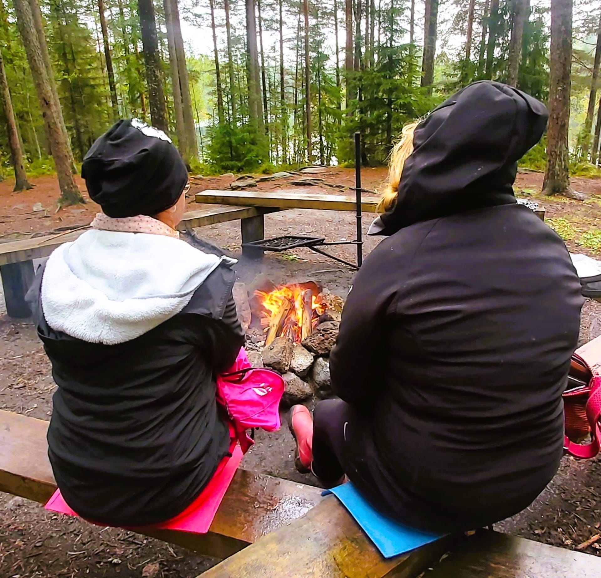 Women sitting by campfire