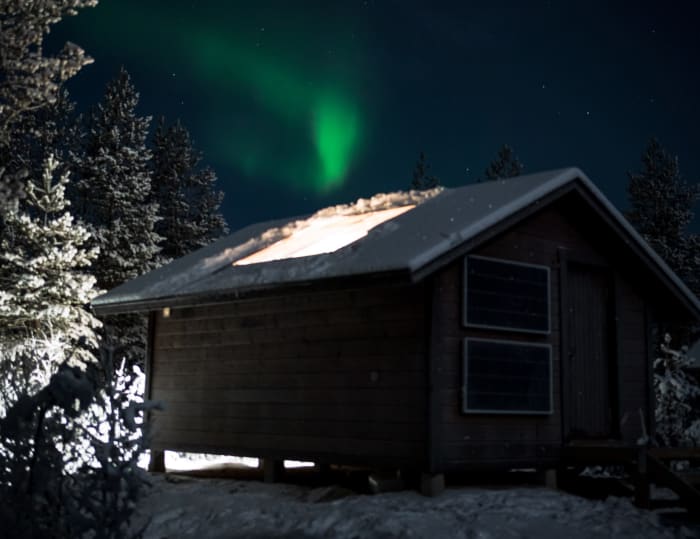 Cabin lights on and Northern Lights