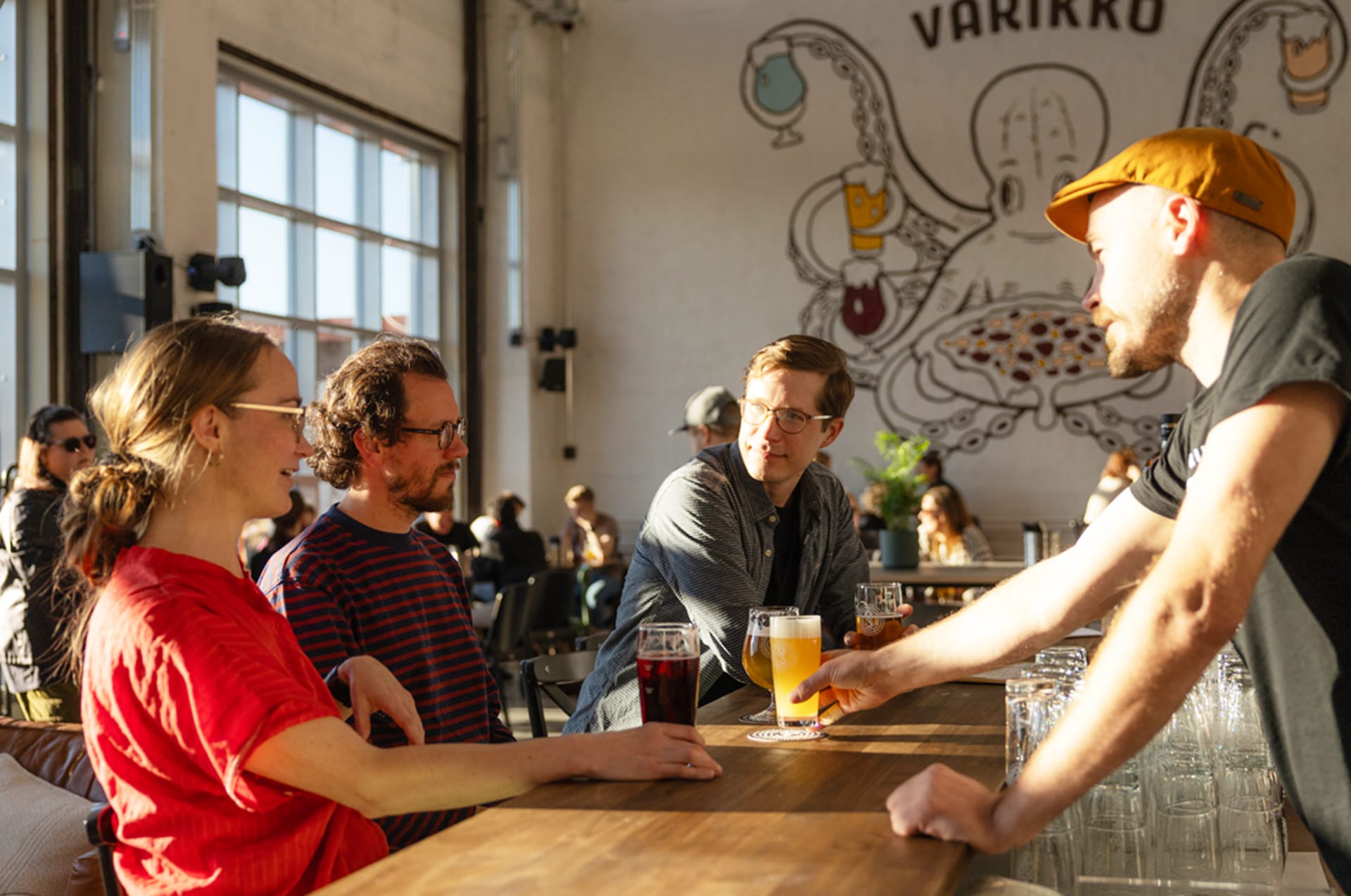 Happy customers enjoying local beers and a friendly chat at Varikko Taproom