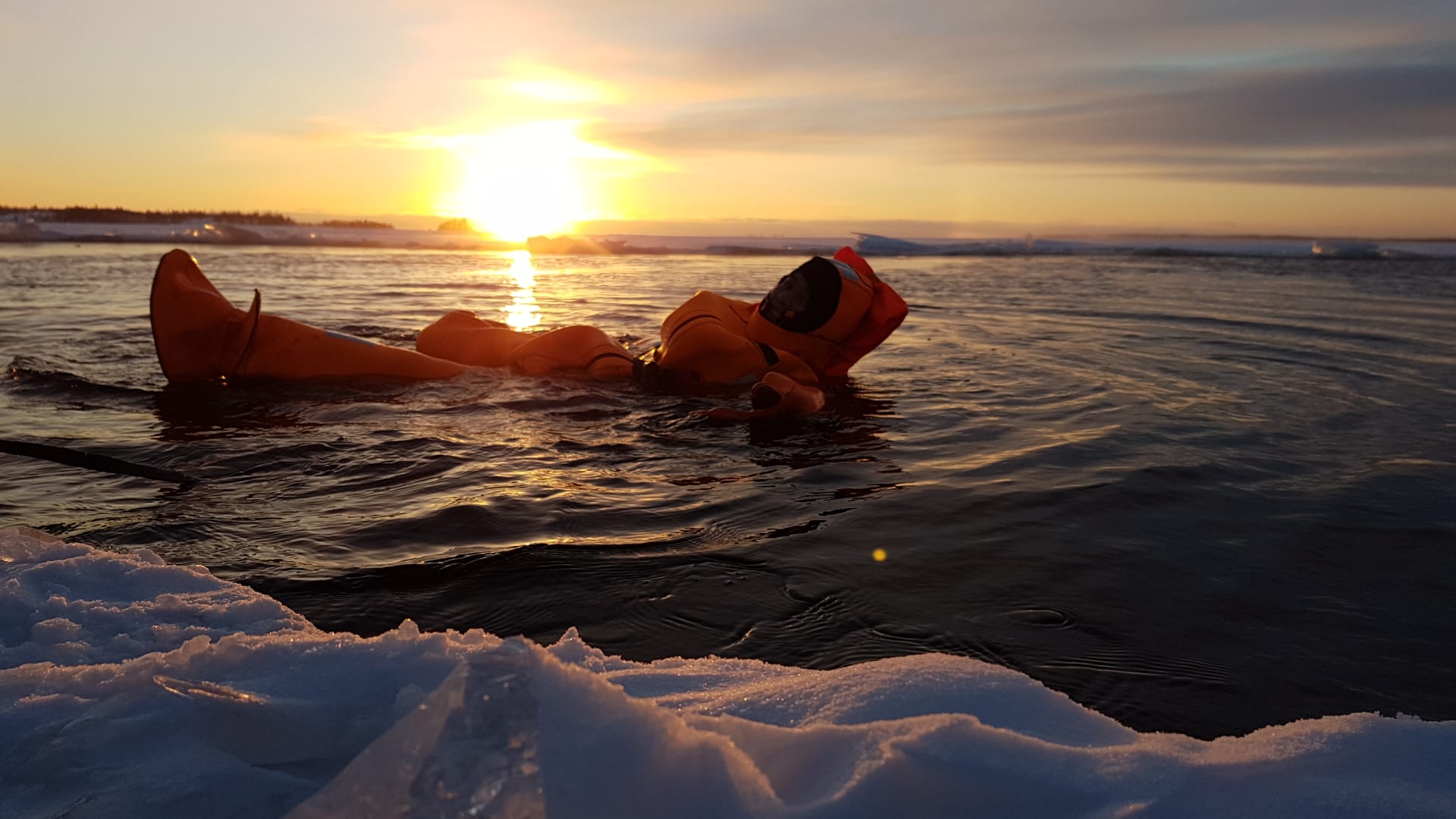 Swimming in survival suit on Polar Explorer icebreaker cruise