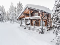 A log house covered with snow.