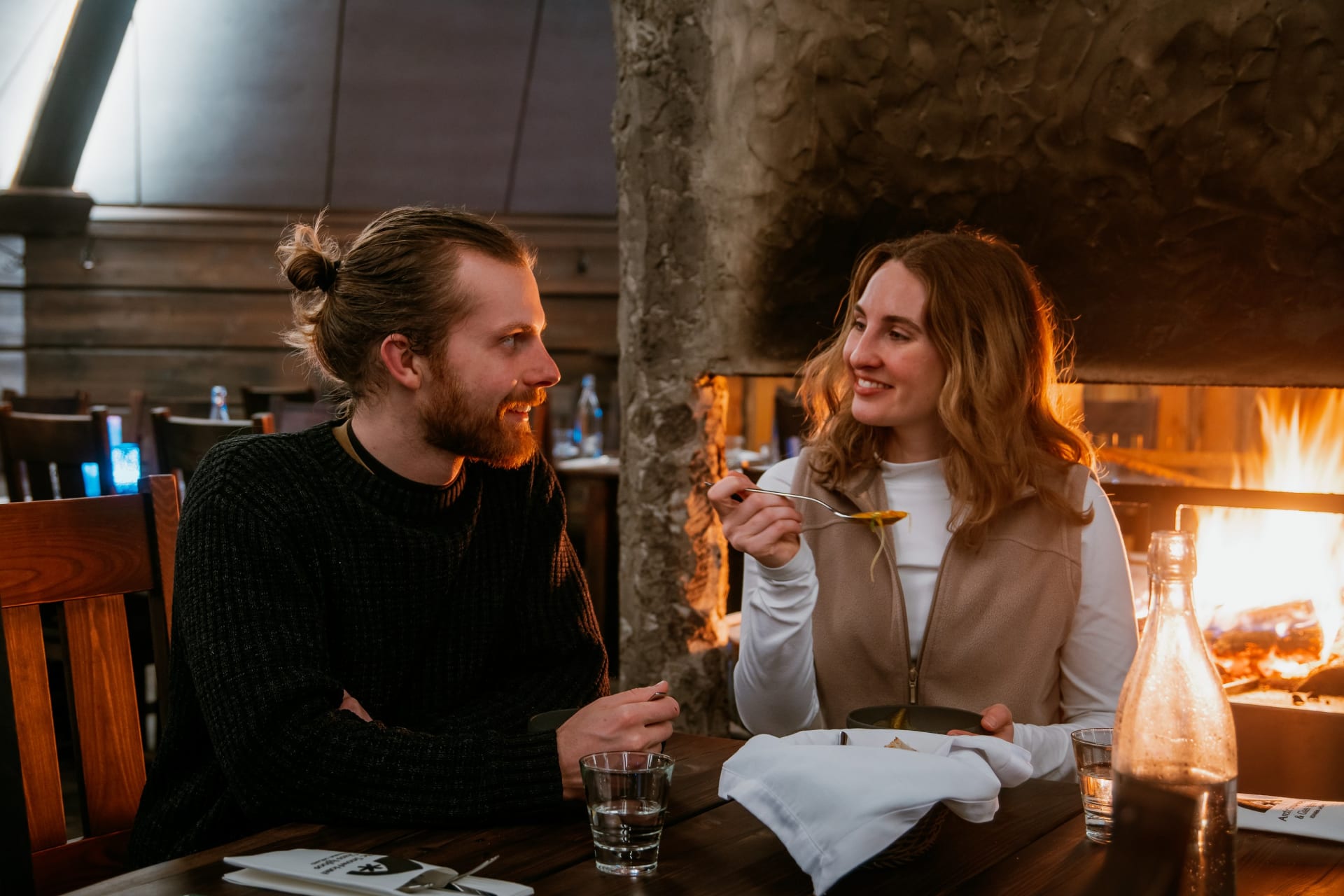 Couple having romantic dinner in Kota Restaurant at Arctic SnowHotel in Rovaniemi, Lapland, Finland