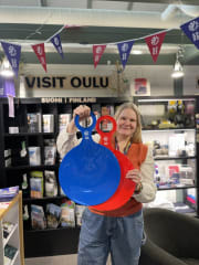 A person holding snow sliders at the Oulu Tourist info