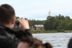 A man taking a photo of the Säppi lighthouse