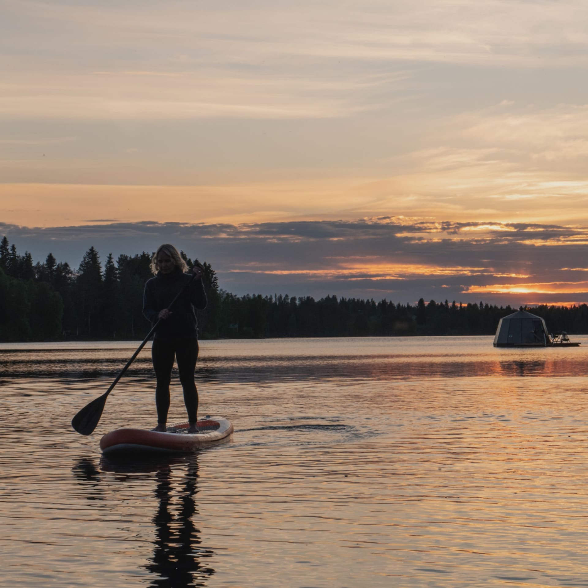 Stand up paddling at lake Ranuanjärvi in Finnish Lapland