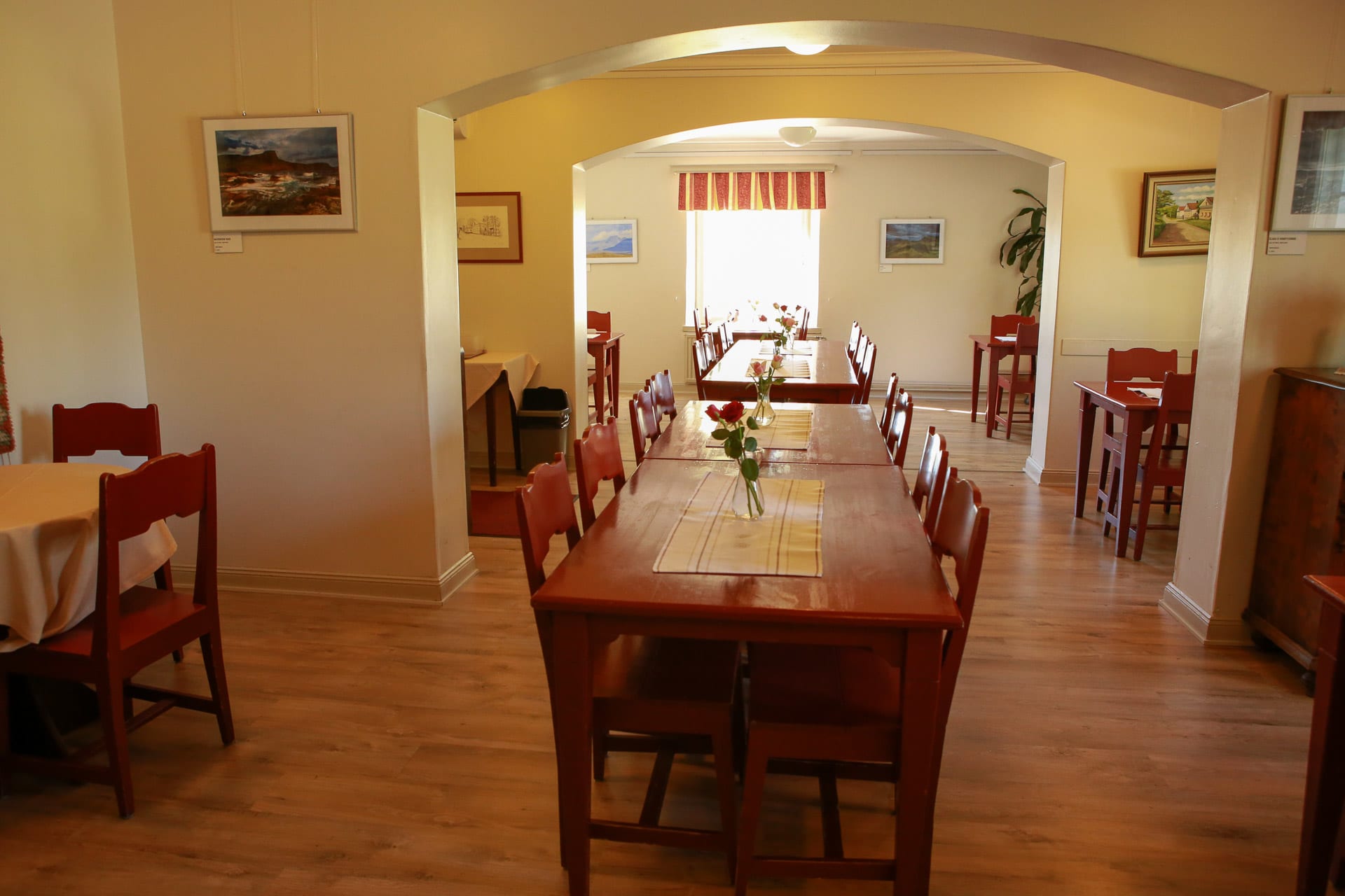 Dining room of Tuorlan Majatalo with red, wooden tables and chairs.  Dining room of Tuorlan Majatalo with red, wooden tables and chairs.
