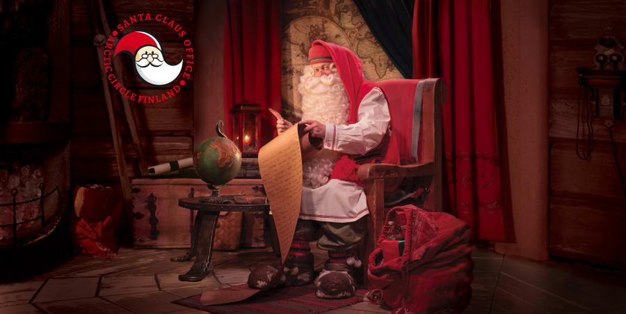 Santa Claus in his office writing a letter.