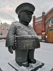 Snow covered policeman statue.