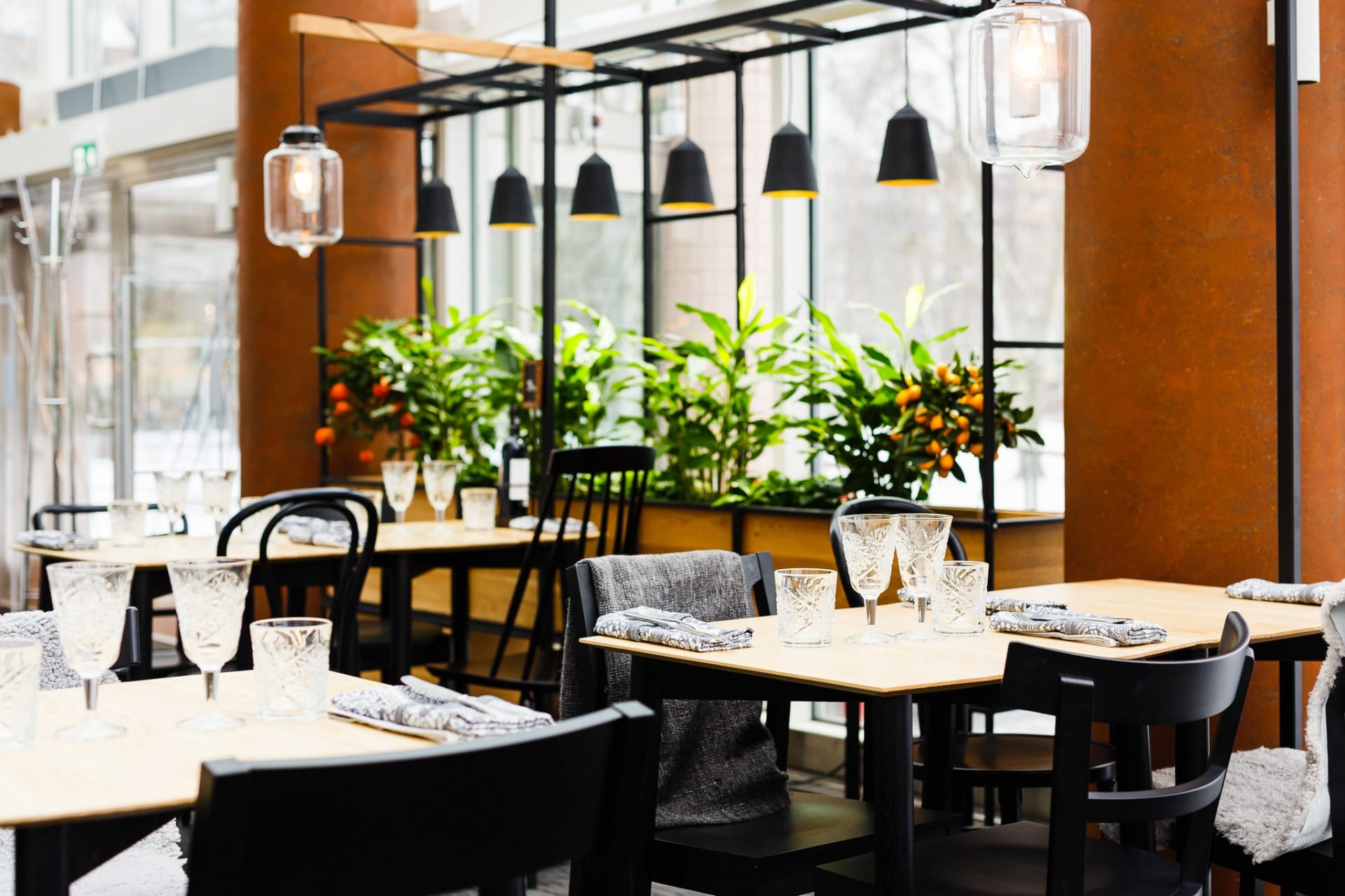 Restaurant Tuhto´s cozy interior with warm wooden tones and green plants