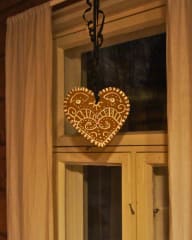 A large gingerbread hanging by a window