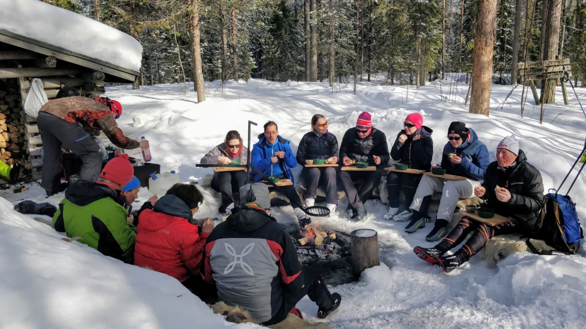 A group around a fire place having lunch